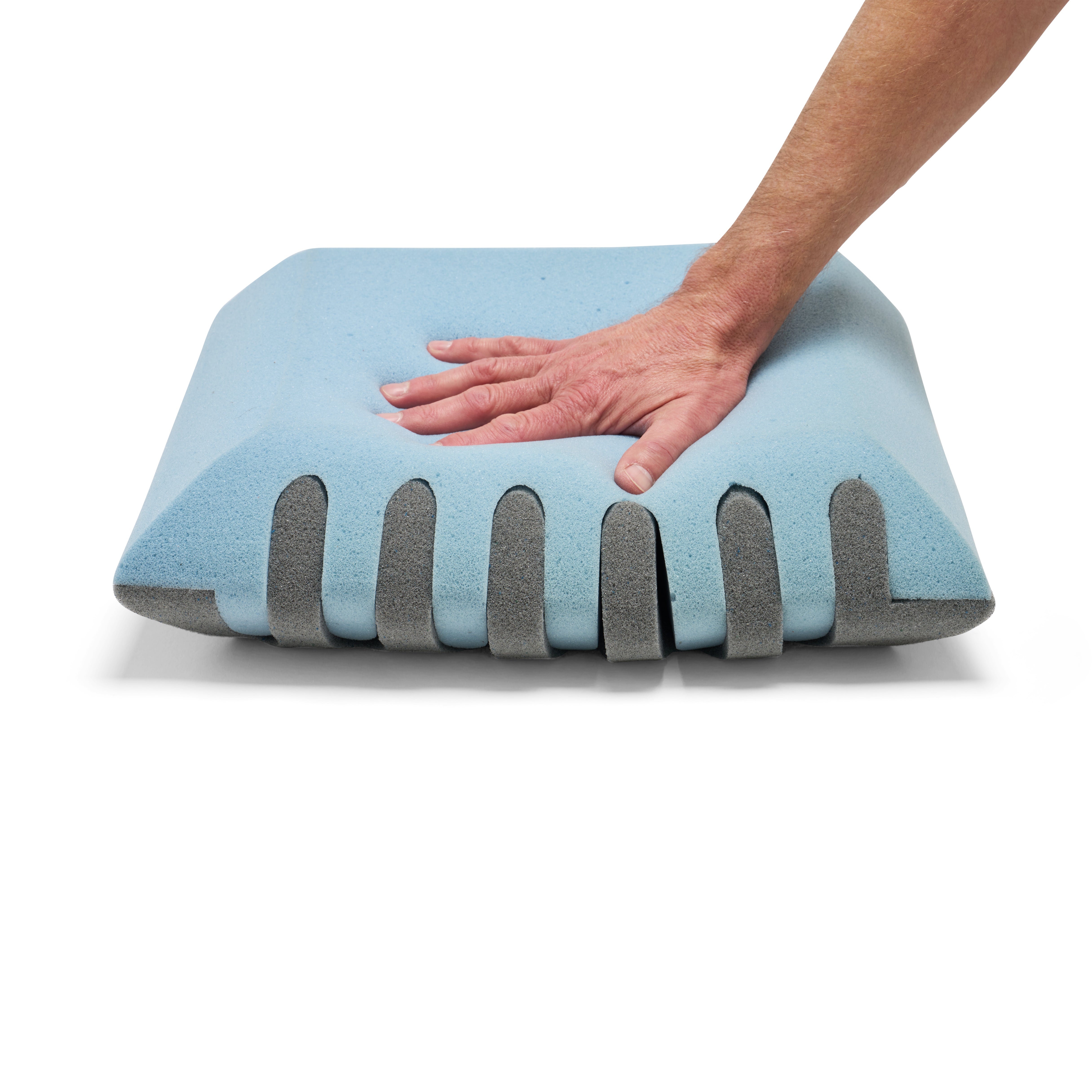 Light blue pillow with gray accents being pressed by a hand on a white background