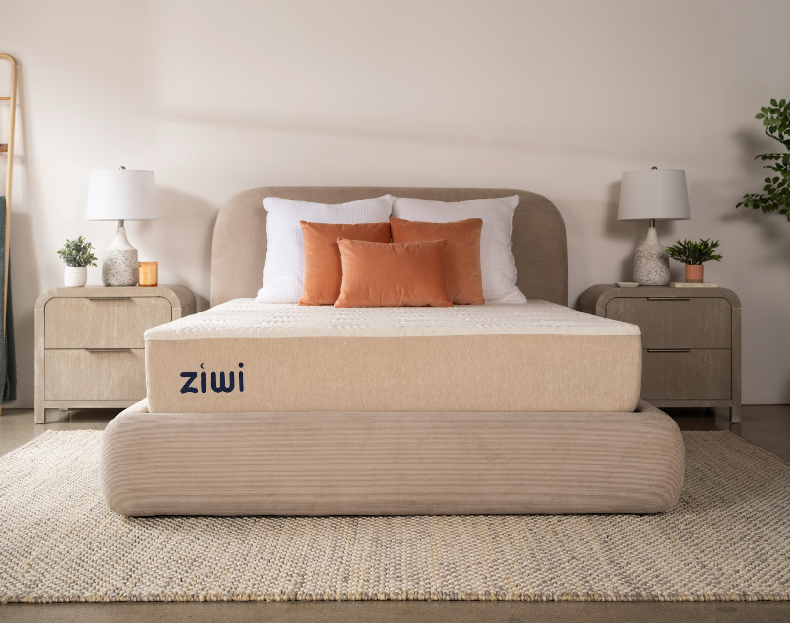 Beige mattress with 'ziwi' branding in a bedroom setting.