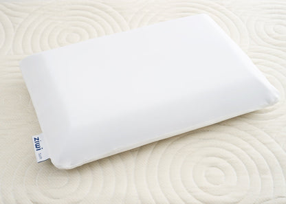 White Ziwi ZiPP pillow on an oatmeal-colored Ziwi mattress