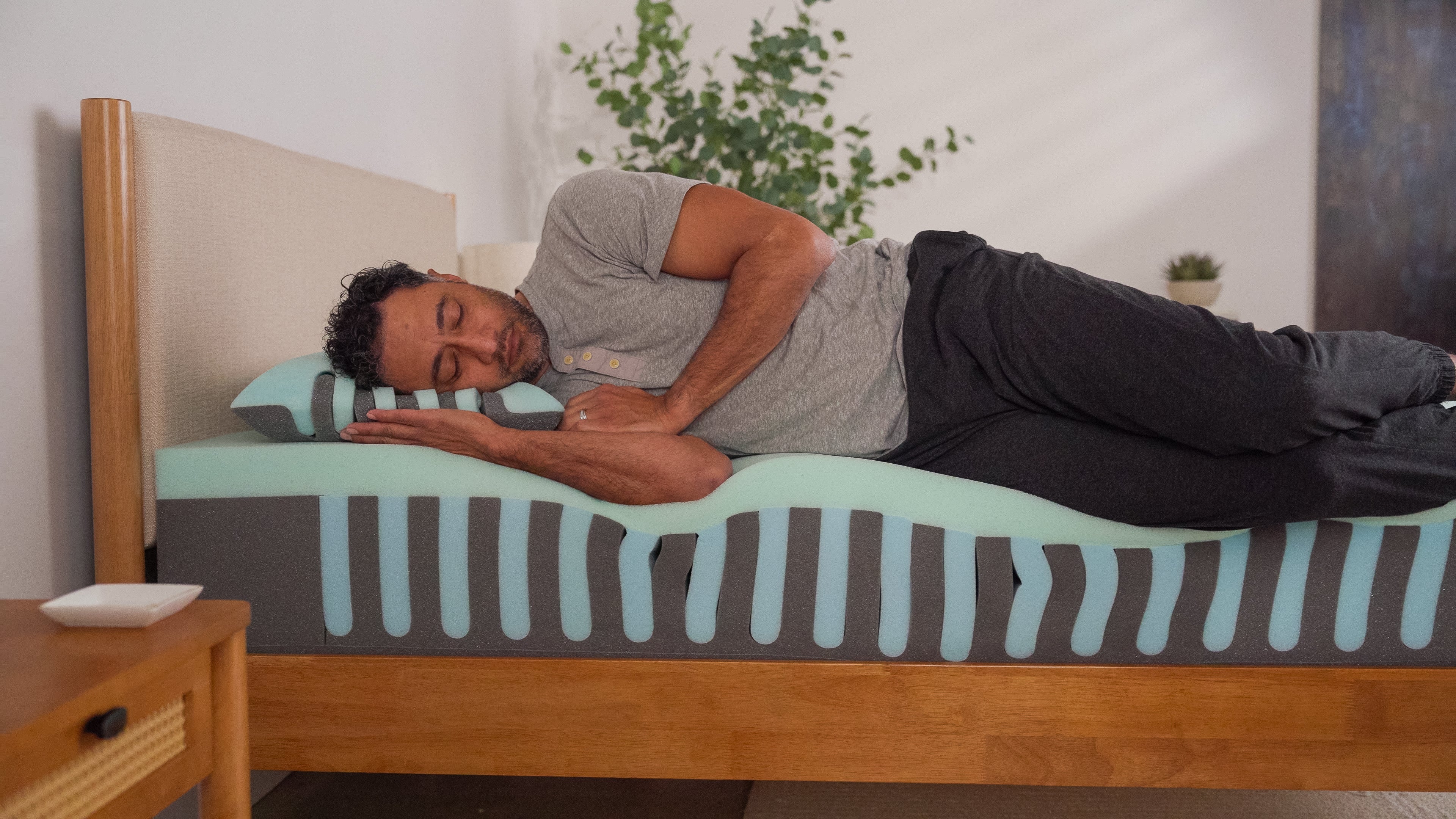 Man lying on a bed with Ziwi Zipp tech showing cover in a bedroom setting