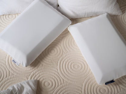 Two white pillows on a textured Ziwi mattress cover